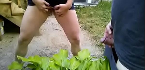  Couple pissing together on a plant